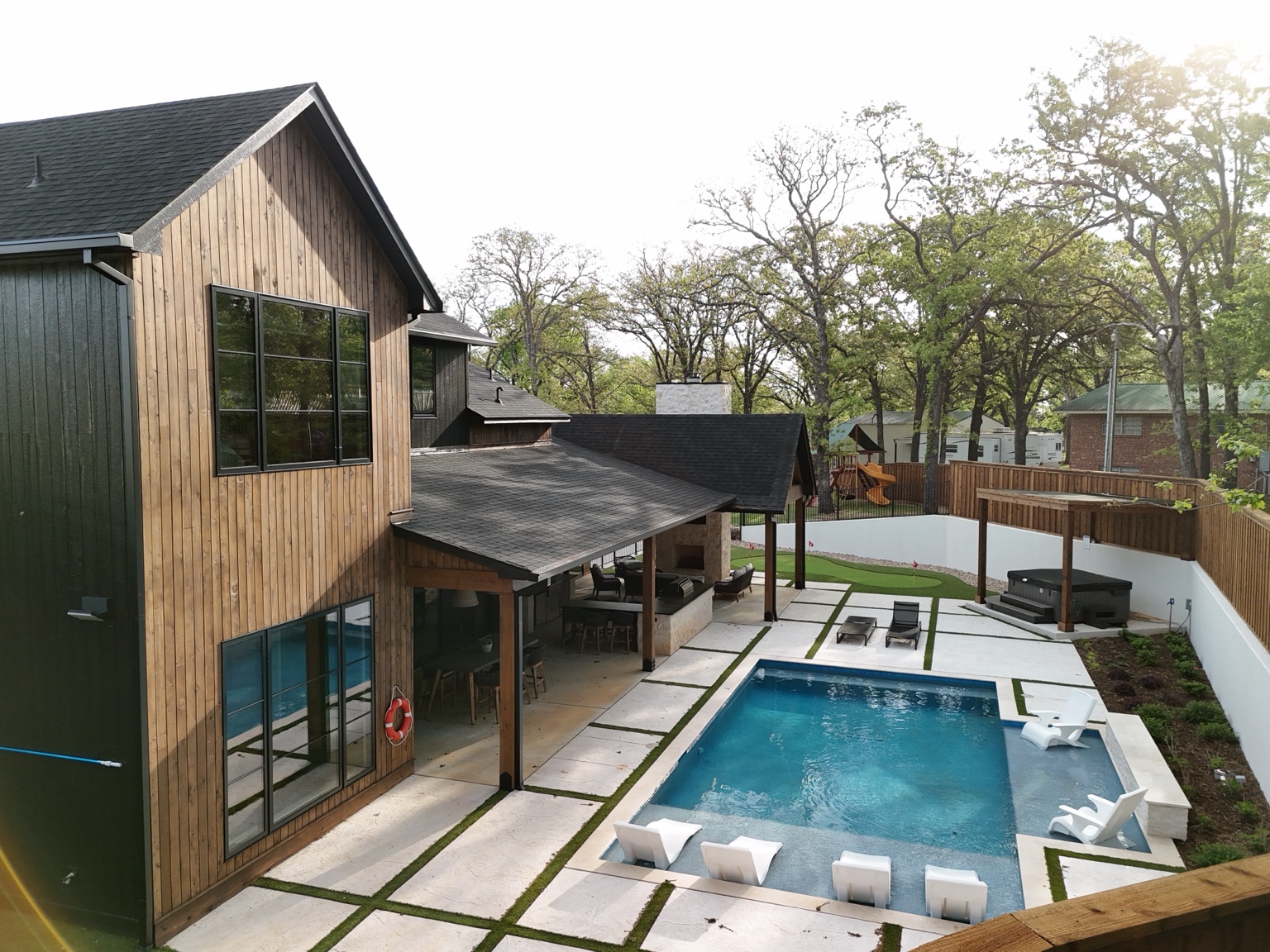 Aerial view of pool, patio and backyard amenities