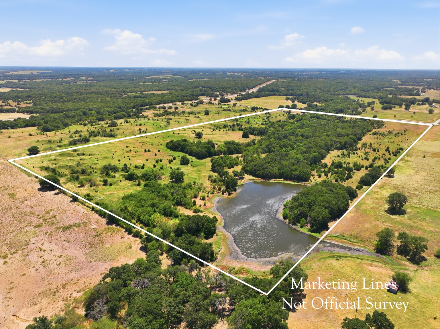 Aerial acreage with pond and wooded areas