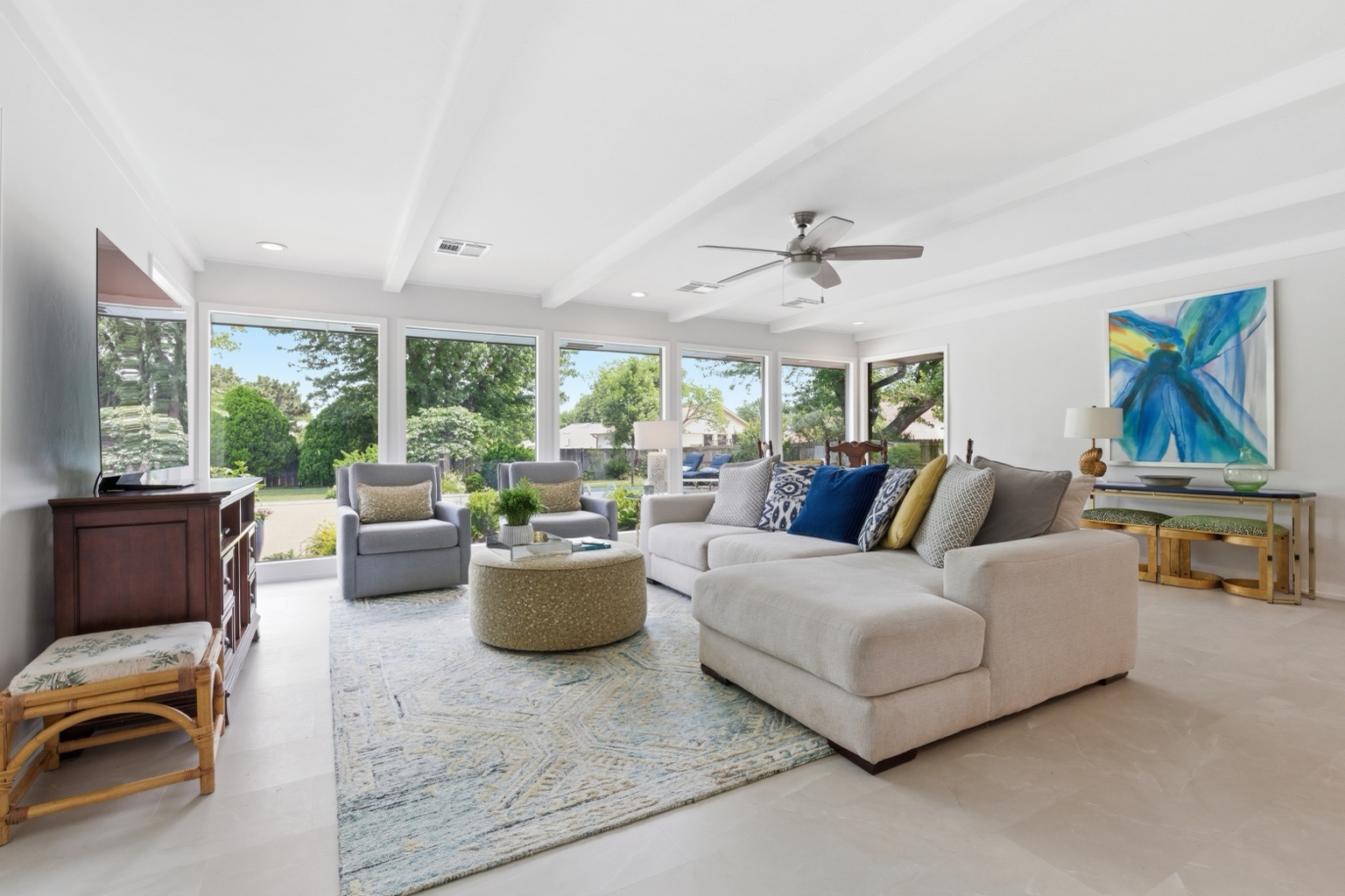 Staged living room with sectional sofa and natural light