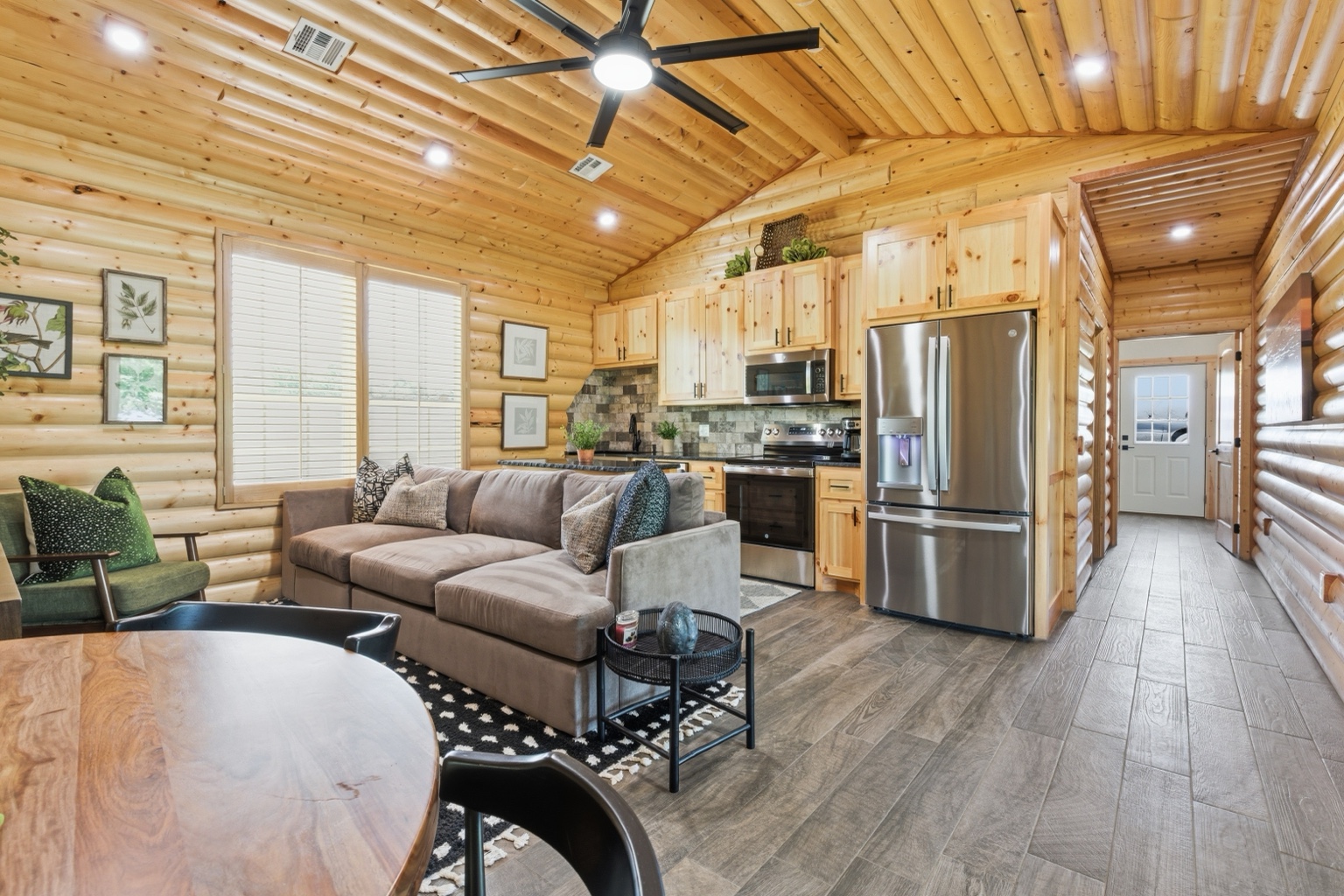 Log cabin interior with wood walls and kitchen
